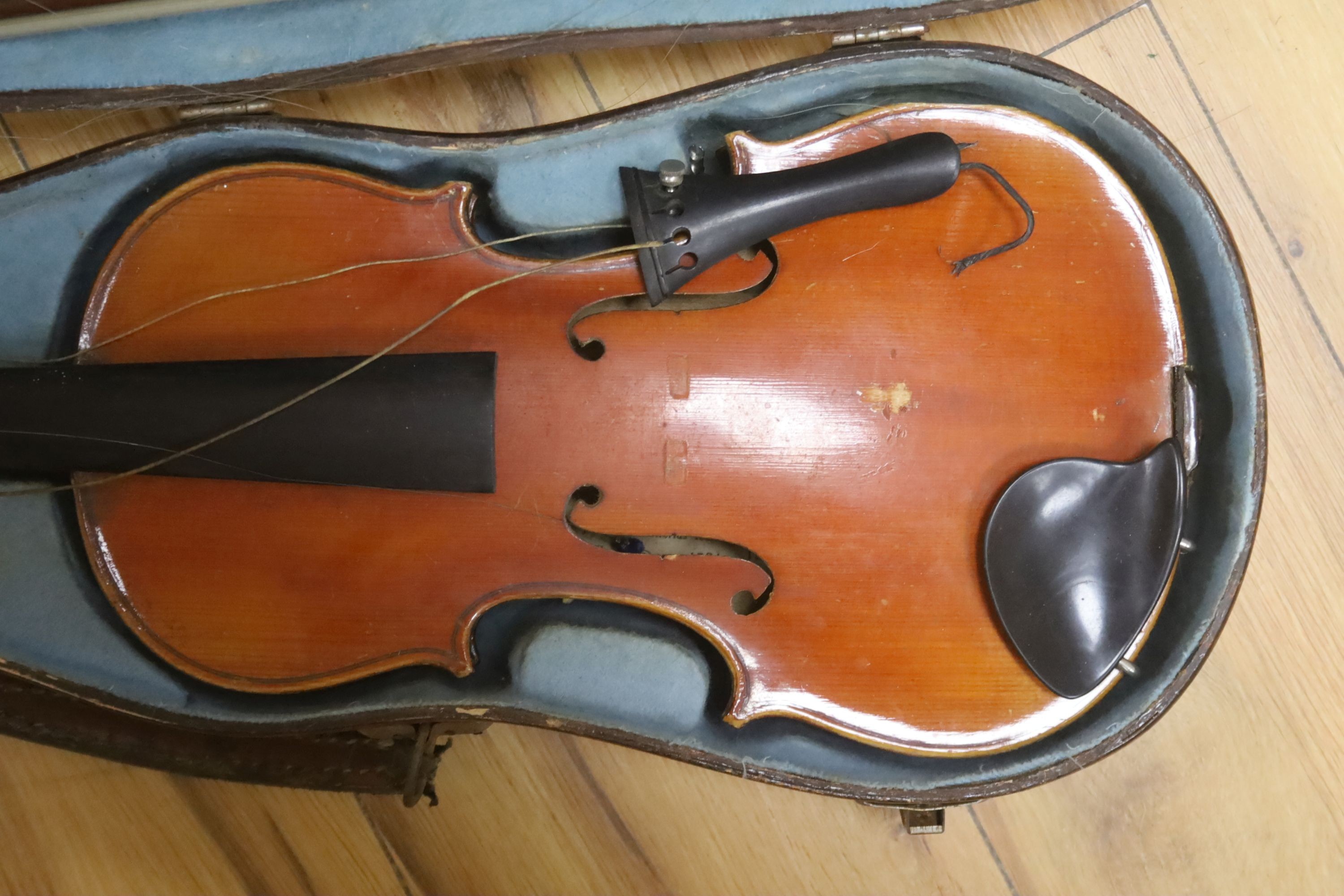 A Stradivarius copy violin and two bows and another bow, both cased, backs 33cm and 30cm